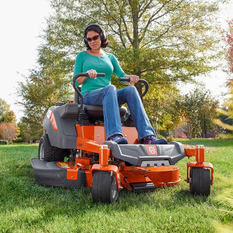 Woman on riding lawnmower width=